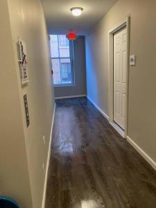 an empty room with a hallway with a door at Downtown Albany 1 Bed + Workstation @ Maiden Lane in Albany