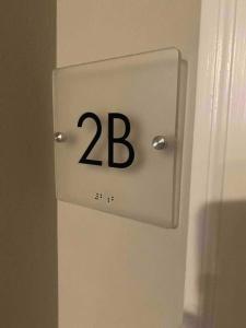 a sign on a door with the number on it at Downtown Albany 1 Bed + Workstation @ Maiden Lane in Albany