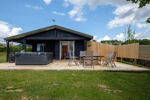 a gazebo with a table and chairs in a yard at Ash Lodge - Exclusive Lodge with Hot Tub and stunning views in Bradpole