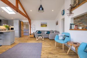 a living room with a couch and chairs and a table at Ash Lodge - Exclusive Lodge with Hot Tub and stunning views in Bradpole