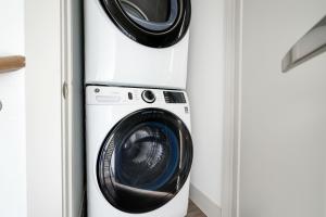 a washing machine and a washer and dryer in a room at Downtown 2br w gym deck nr Congress Ave ATX-212 in Austin