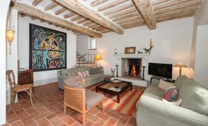 a living room with a couch and a fireplace at Casa Tabarro in Camaiore