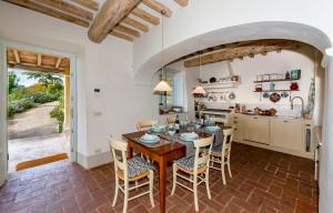 a kitchen and dining room with a wooden table and chairs at Casa Tabarro in Camaiore