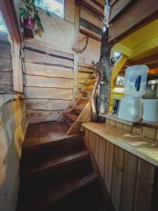 a stairway leading to the kitchen of a tiny house at Cabañas Los Cantos del Chucao in Puerto Varas