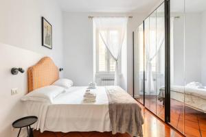 a bedroom with a bed and a large window at Colosseo 85 in Rome
