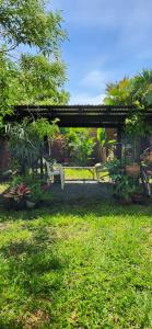 a person sitting on a bench in a garden at Casa amplia con zonas verdes y cerca a la Basílica in Buga