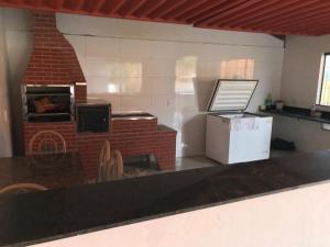 a kitchen with a brick oven in a room at Rancho Chega Mais 1 in Carmo do Rio Claro