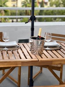 uma garrafa de vinho num balde numa mesa com copos em Terrazza Vanvitelli em Caserta