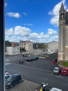 a parking lot with cars parked in a parking lot at Charmant T2 - Plein centre ville in Niort