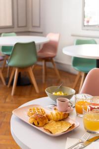 a plate of food on a table with breakfast foods at Hotel Aria in Nice