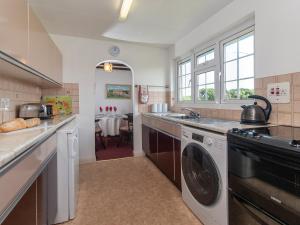 a kitchen with a sink and a dishwasher at The Bickney in Llanrian