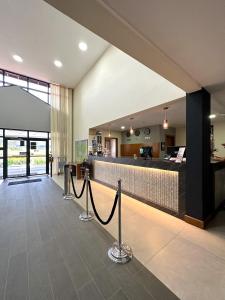 a lobby with a bar in the center of a building at Cegil Hotel Boulevard in Resende