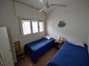 um quarto com 2 camas e uma ventoinha de tecto em Nirvana em Punta del Este