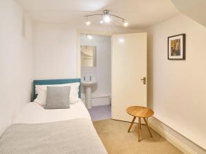 a bedroom with a bed and a bathroom with a sink at Host & Stay - Queen's Corner in Canterbury