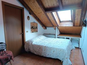 a small bedroom with a bed and a window at Chiara Loft in Stresa
