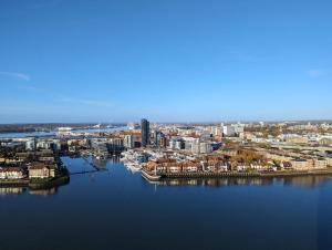 an aerial view of a city with a large body of water at Southampton Waterside by Charles Hope in Southampton