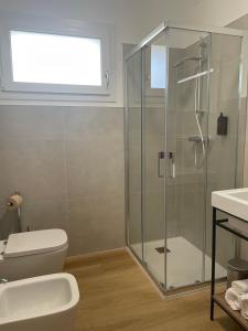 a bathroom with a shower and a toilet and a sink at Borgo Terra village in Fagagna