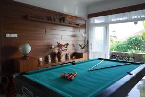 a pool table in a living room with a pool table at Guildwood Villa Bali in Sanur