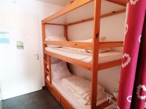 a room with a wooden bunk bed with pillows at Appartement Saint-François-Longchamp, 2 pièces, 4 personnes - FR-1-635-54 in Saint-François-Longchamp