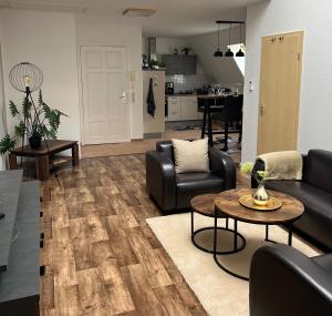 a living room with a couch and a table at Apartment ZUR ALTEN POST in Osterburg