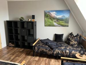 a bedroom with a bed and a book shelf at Apartment ZUR ALTEN POST in Osterburg