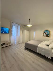 a bedroom with a bed and a flat screen tv at B&B Due Su Due Holiday in Vietri sul Mare