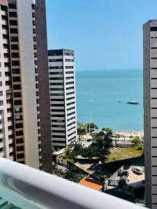 a view of a city with tall buildings and the ocean at Condo c/2 Suites a 200m da Beira Mar - Vista Mar in Fortaleza