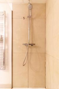 a shower with a shower head in a bathroom at Wonder Appart' 402 - Vue sur Garonne in Toulouse