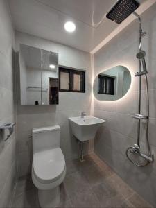 a bathroom with a toilet and a sink at Jamsil Geram in Seoul