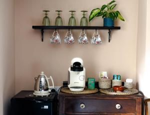 a table with a coffee maker on top of a dresser at Anne Boleyn’s Escape in Deal