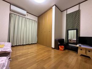 a room with a bedroom with a bed and a mirror at Numazu Ikyuuan 沼津一休庵 in Numazu