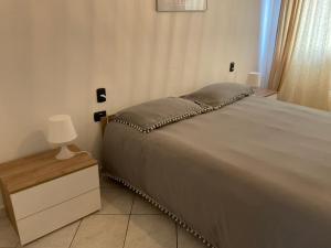 a bedroom with a bed and a lamp on a night stand at Appartamento Repubblica 2 in Prato