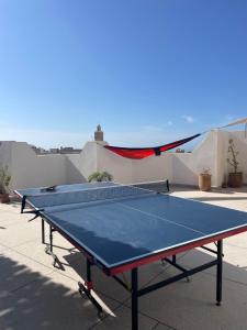 a ping pong table sitting on top of a roof at Wavy Days in Tamraght Ouzdar