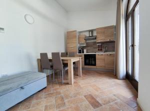 cocina y comedor con mesa y sillas en Poggio Imperiale Marche - Apartments & Glamping & Bubble Rooms, en Civitanova Marche