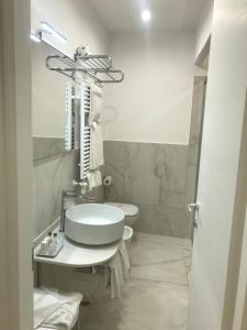a bathroom with a sink and a toilet at Amalfi Suite Boutique Hotel in Amalfi