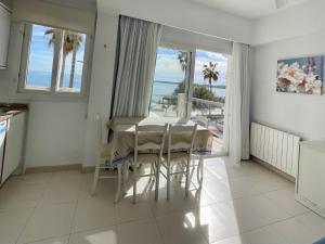 a dining room with a table and a view of the ocean at Arcadia in Cala Millor
