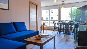 a living room with a blue couch and a table at GALEON sea view apartment in Benidorm