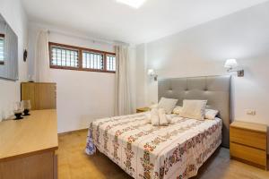 a bedroom with a large bed in a room at Beautiful Arenas Negras By Paramount Holidays in Puerto de Santiago +27 photos
