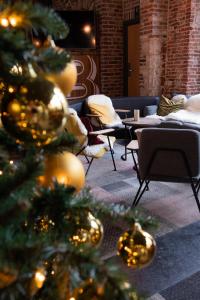 a christmas tree in a room with tables and chairs at Novotel Gent Centrum in Ghent