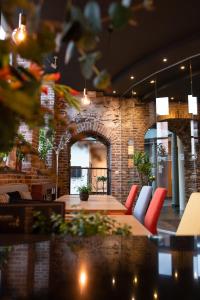 a restaurant with red chairs and a brick wall at Novotel Gent Centrum in Ghent