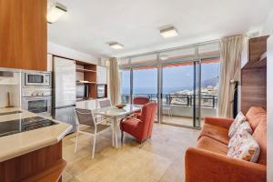 a kitchen and living room with a view of the ocean at Beautiful Arenas Negras By Paramount Holidays in Puerto de Santiago