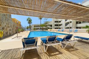 a deck with two chairs and a swimming pool at Beautiful Arenas Negras By Paramount Holidays in Puerto de Santiago