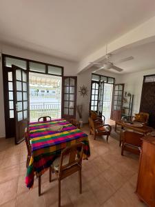 a living room with a table with a colorful blanket on it at Villa Flora, escapade champêtre in Petit-Canal