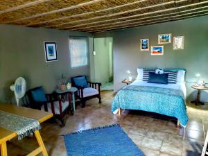 1 dormitorio con 1 cama, mesa y sillas en Duiker's self catering Accommodation en Askham