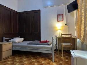 Postel nebo postele na pokoji v ubytování Kecskeméti Rooms