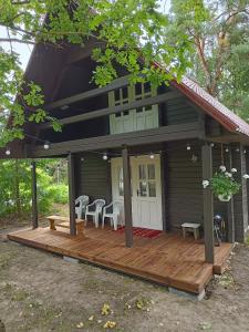 a house with a wooden deck in front of it at Cosy Holiday Home with sauna for family vacation 