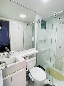 a bathroom with a toilet and a glass shower at Condo c/2 Suites a 200m da Beira Mar - Vista Mar in Fortaleza