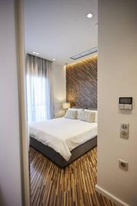 een slaapkamer met een bed en een groot raam bij A3_Aplotaria Architect's Apartment in Chios