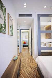a bedroom with a bed and a wooden floor at A3_Aplotaria Architect's Apartment in Chios