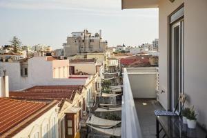 a view of a city from the balcony of a building at A3_Aplotaria Architect's Apartment in Chios